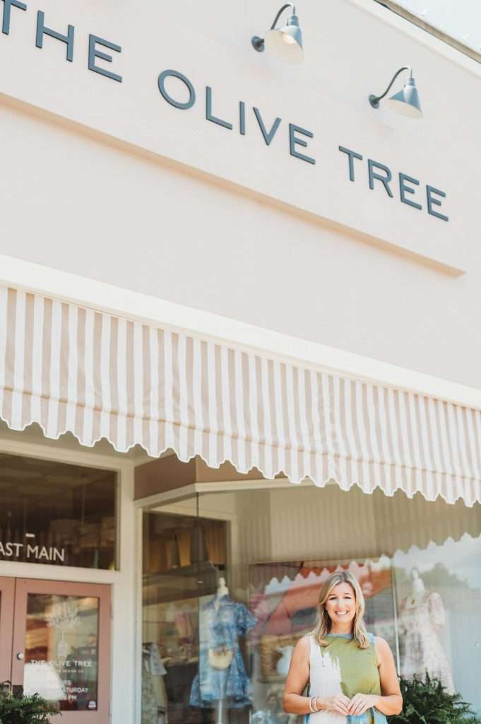 Mary Clair Cumbaa standing in front of the exterior of The Olive Tree