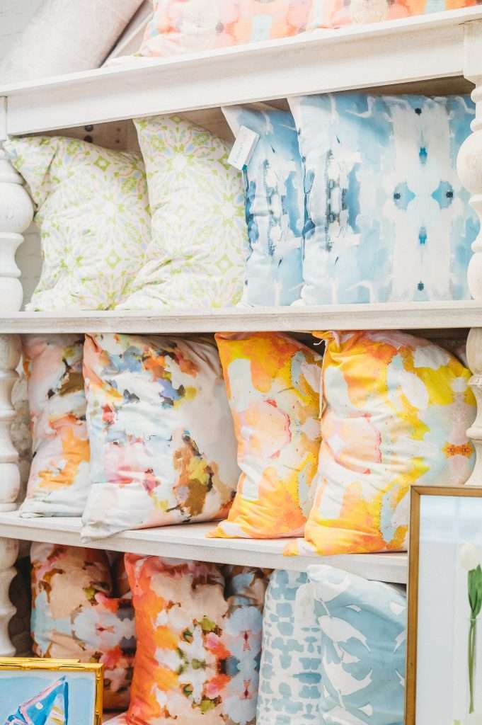 Britghtly colored pillows on shelves